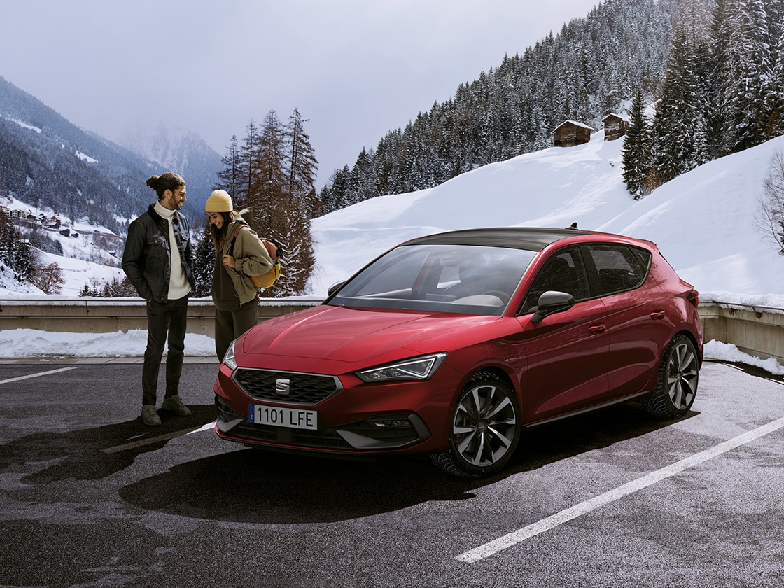 A red seat car in a snowy mountain setting with car insurance for vehicle coverage.