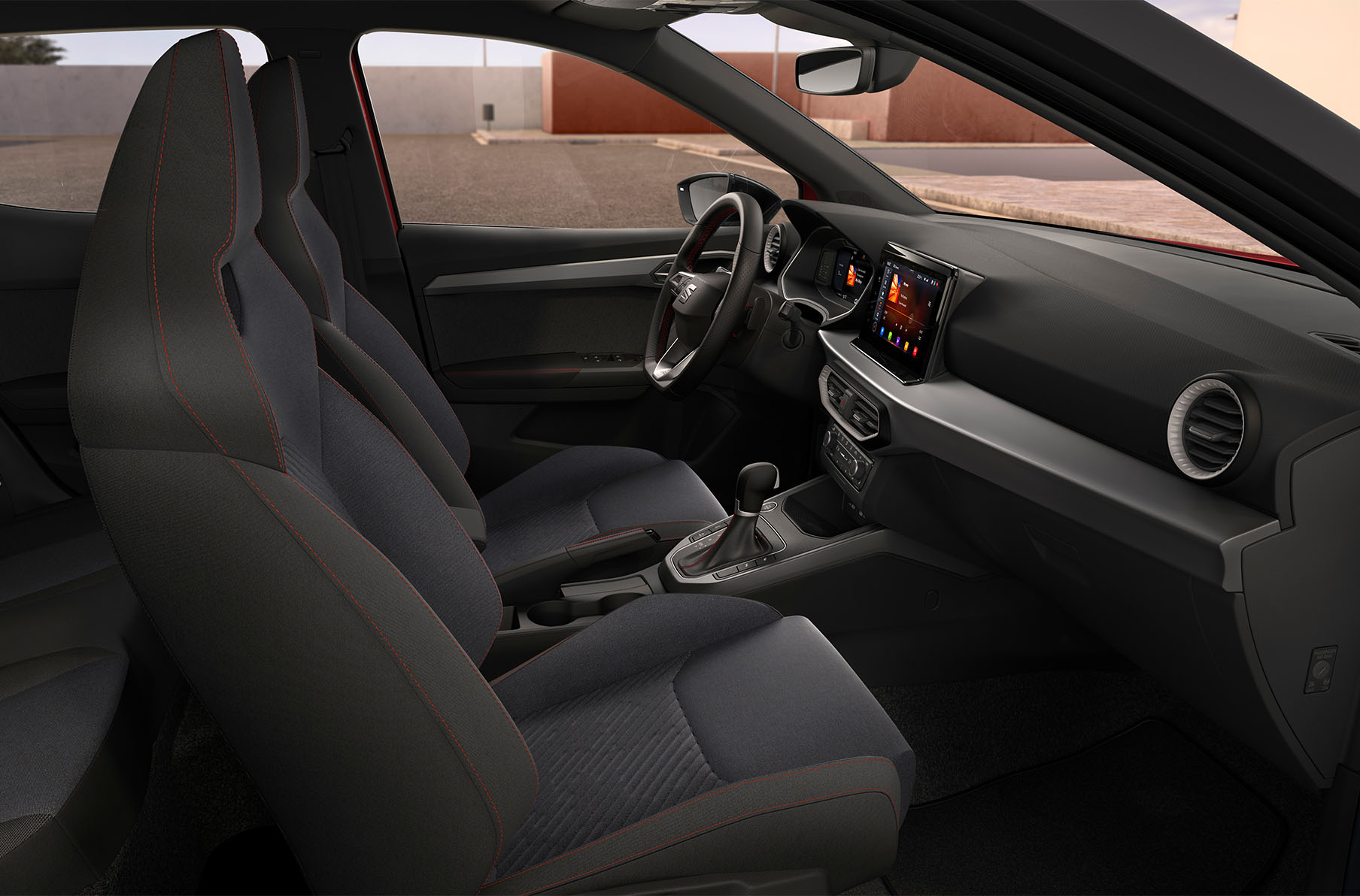 Side view of the seat arona fr interior for the black edition, featuring sport bucket seats with red stitching, grey air vents and dark aluminium matte dashboard and door mouldings.