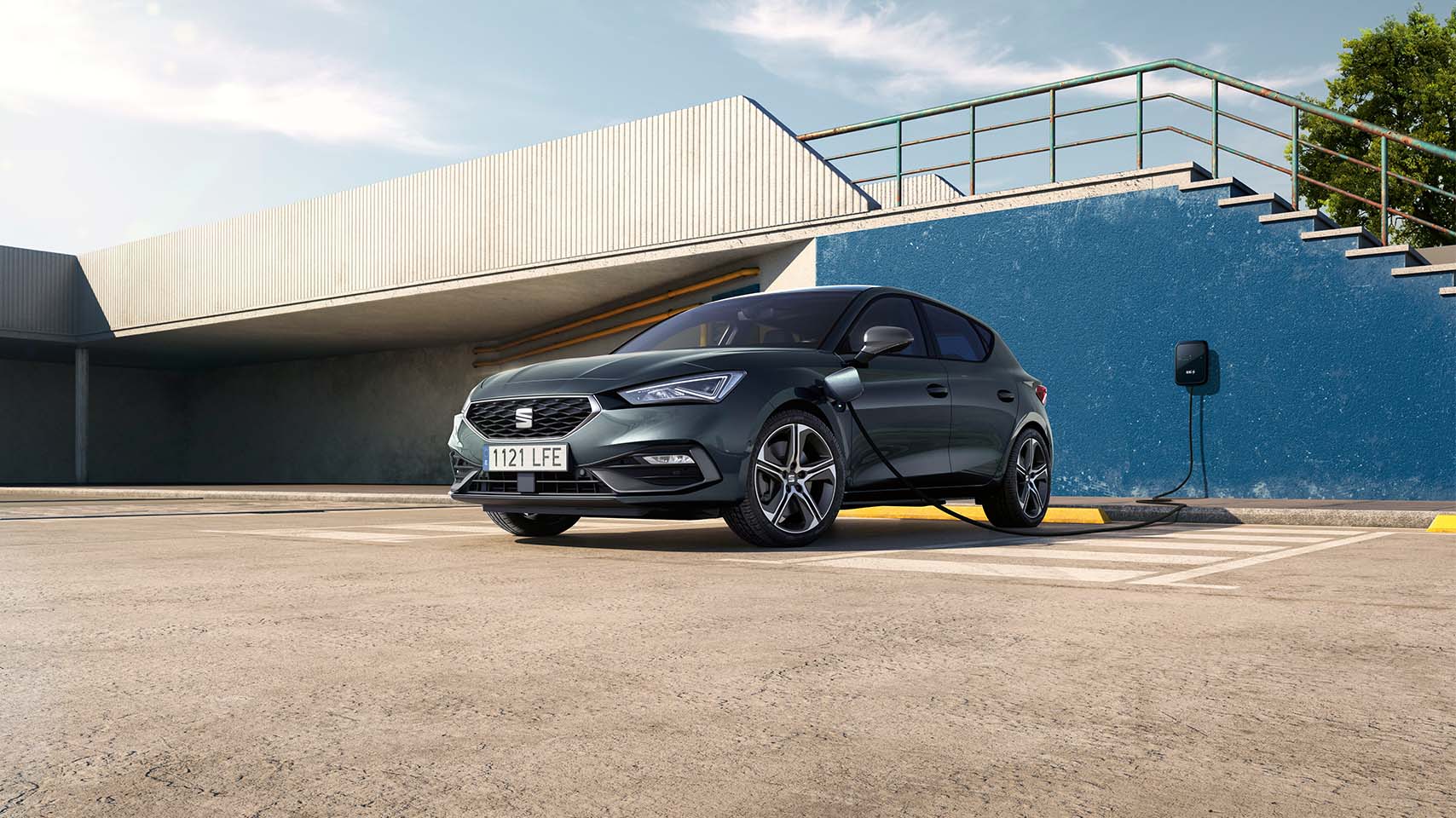 Seat leon charging in a public car park with a wall charger, low angle shot