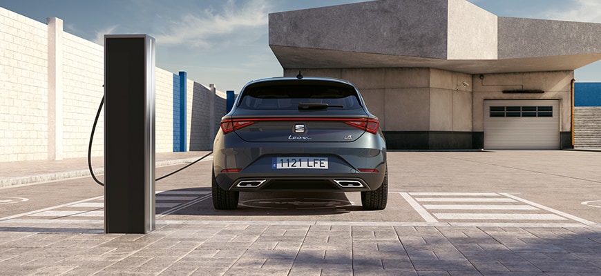 seat leon phev at a charging station, illustrating a complete guide to hybrid cars for eco-conscious drivers