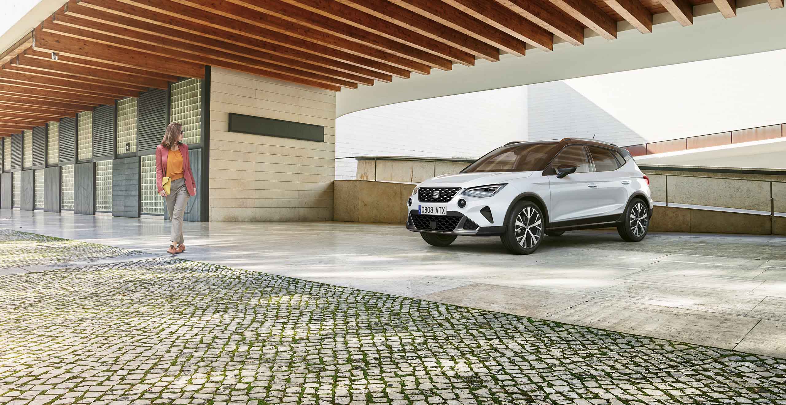 Two SEAT Arona parked, one dark camouflage colour and another Sapphire Blue colour 