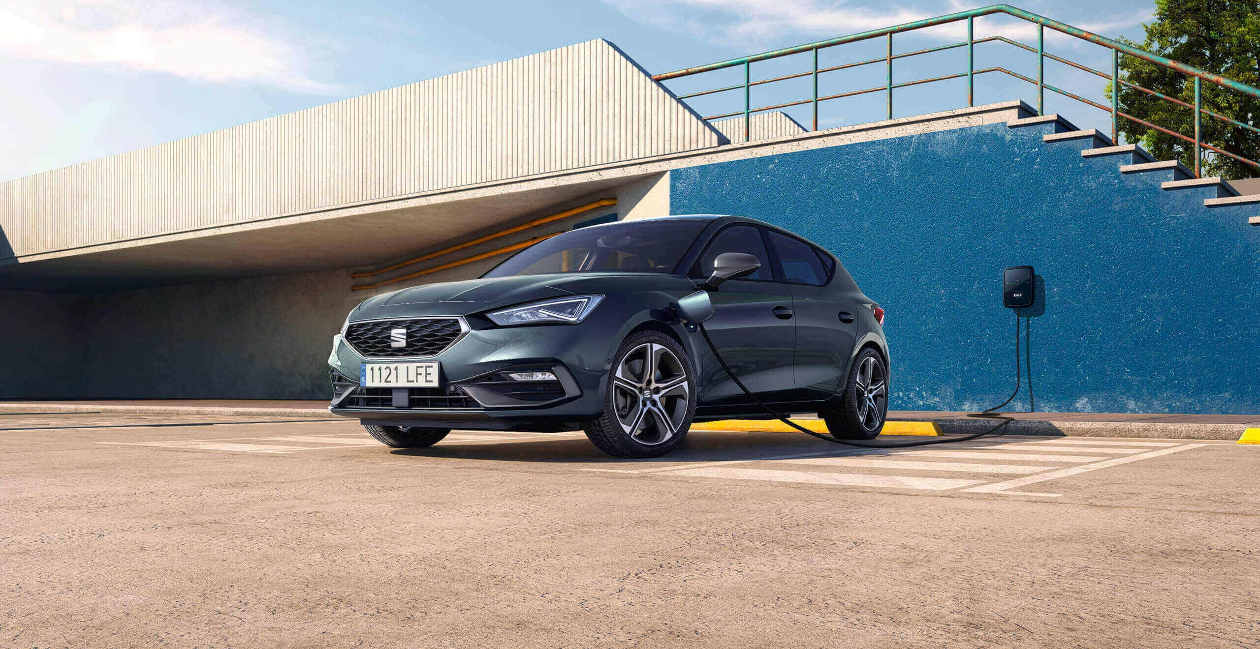 connected to a charging point in a car park, emphasising convenient plug-in hybrid charging options.